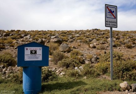 Знак, запрещающий купаться в канале посреди пустыни.