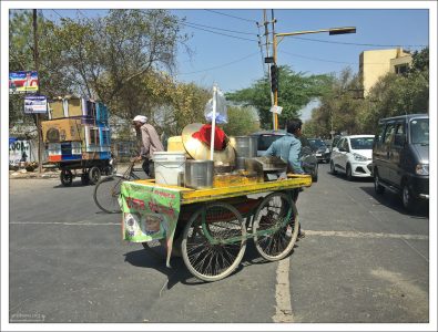 Уличный торговец пытается пересечь улицу.