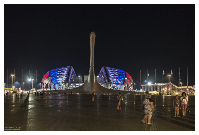 Стадион Фишт вечером подсвечивают в цветах Российского флага.