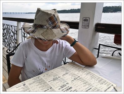 Саша изучает меню в ресторане "Старая пристань".