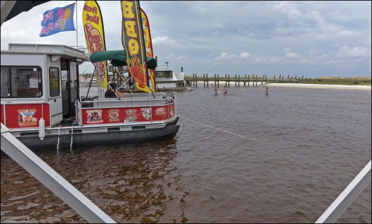 Понтонные лодки у причала на острове Shell Island, Флорида.