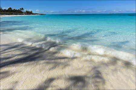 На Багамах в основном присутствует мелкий коралловый песок, богатый карбонатом кальция.
Он очень светлый, почти белый, и отражает солнечный свет обратно через толщу воды.
Это усиливает эффект бирюзы, особенно в солнечную погоду.